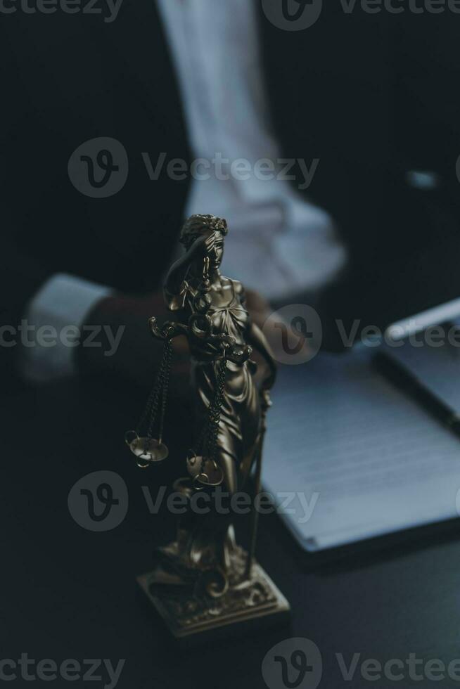 Business and lawyers discussing contract papers with brass scale on desk in office. Law, legal services, advice, justice and law concept picture with film grain effect photo