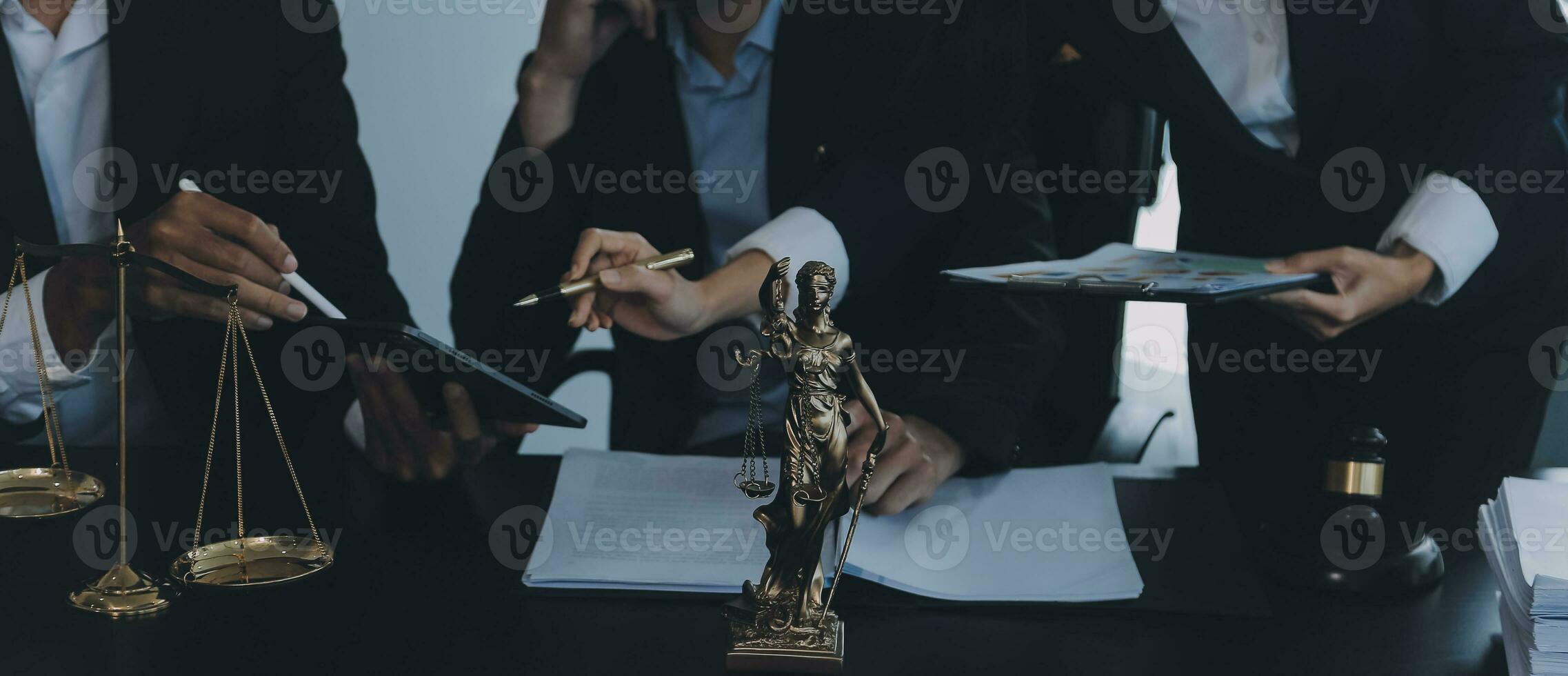 Business and lawyers discussing contract papers with brass scale on desk in office. Law, legal services, advice, justice and law concept picture with film grain effect photo