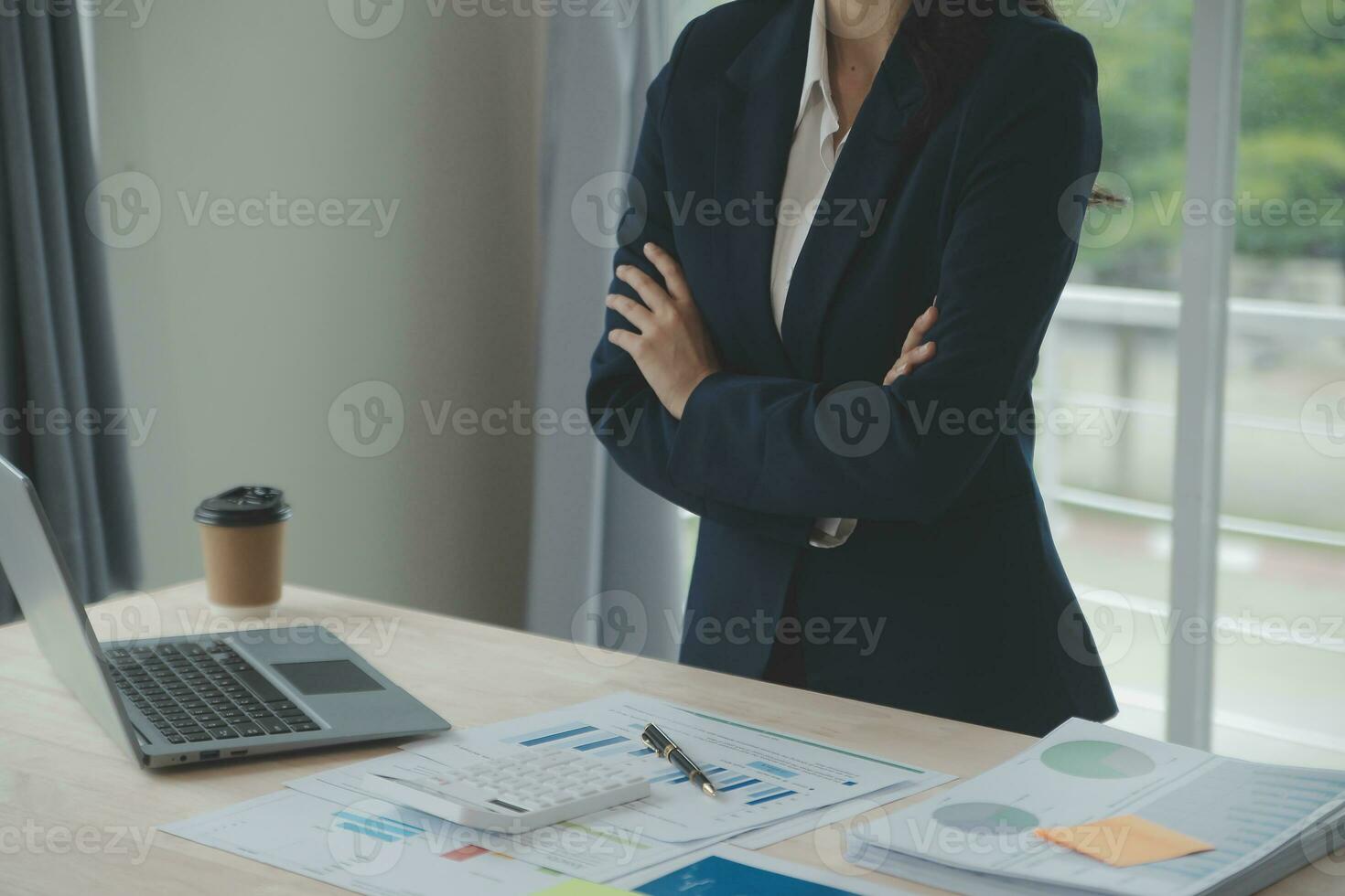 Close up Business woman using calculator and laptop for do math finance on wooden desk, tax, accounting, statistics and analytical research concept photo