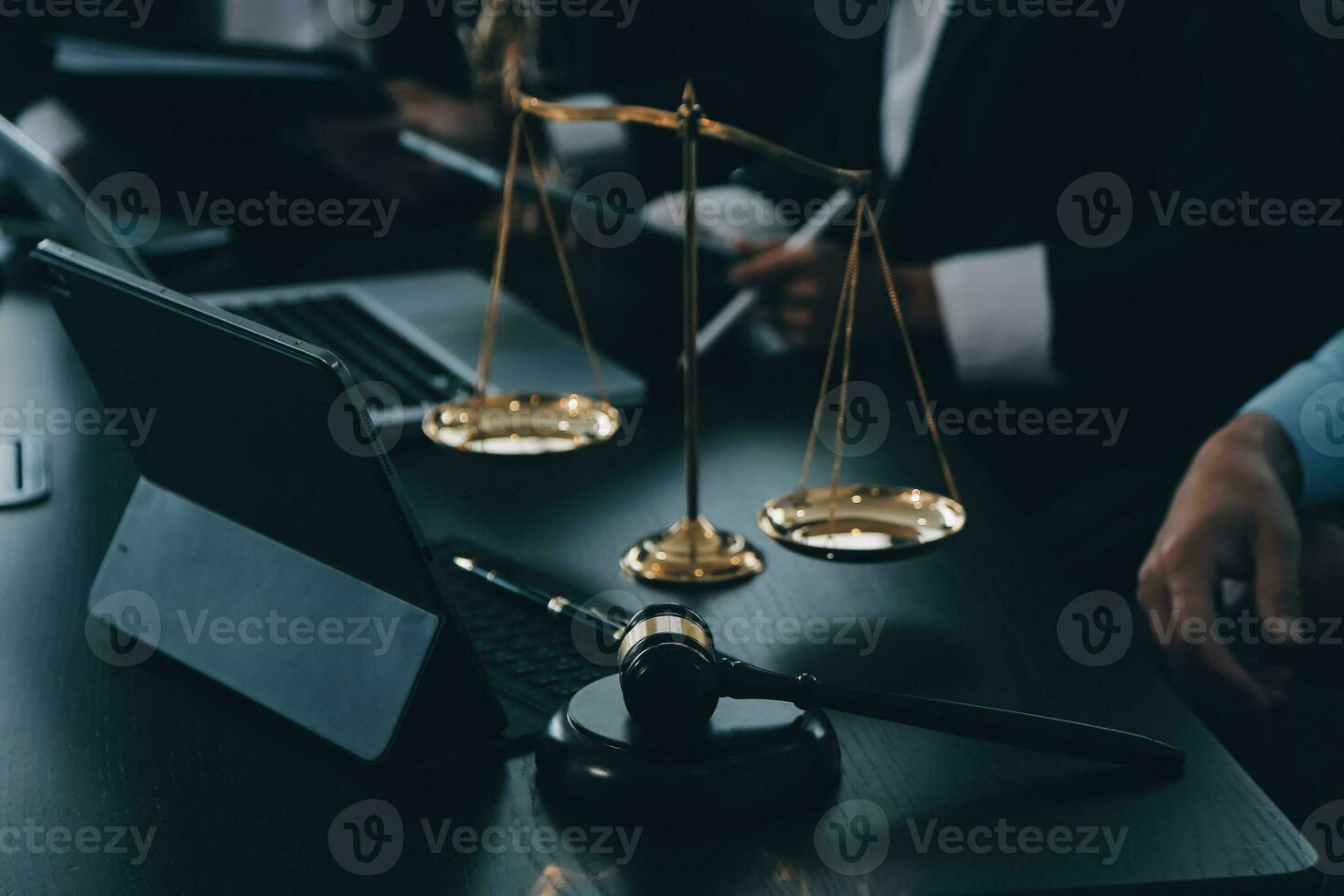 Business and lawyers discussing contract papers with brass scale on desk in office. Law, legal services, advice, justice and law concept picture with film grain effect photo