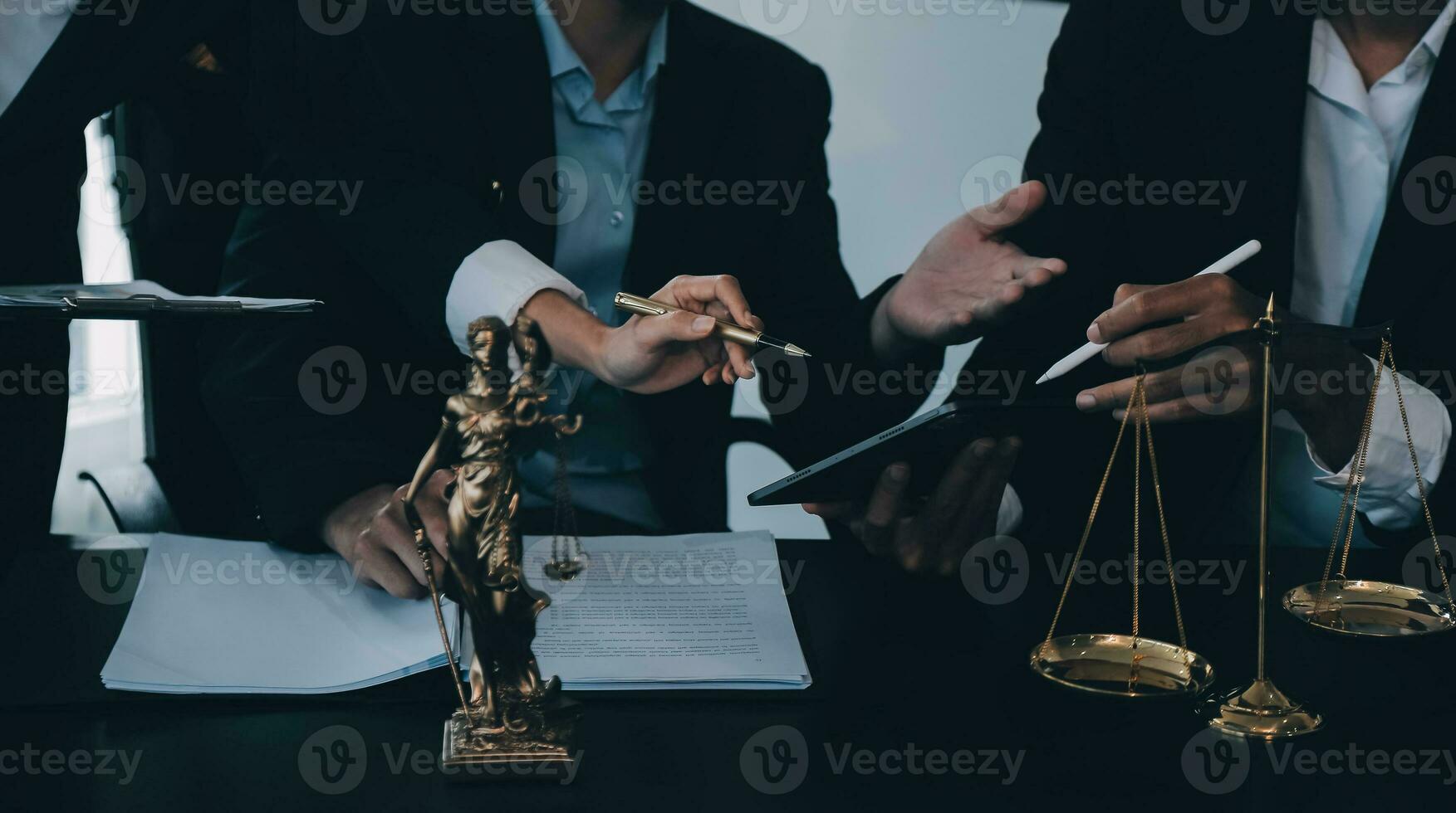 Business and lawyers discussing contract papers with brass scale on desk in office. Law, legal services, advice, justice and law concept picture with film grain effect photo