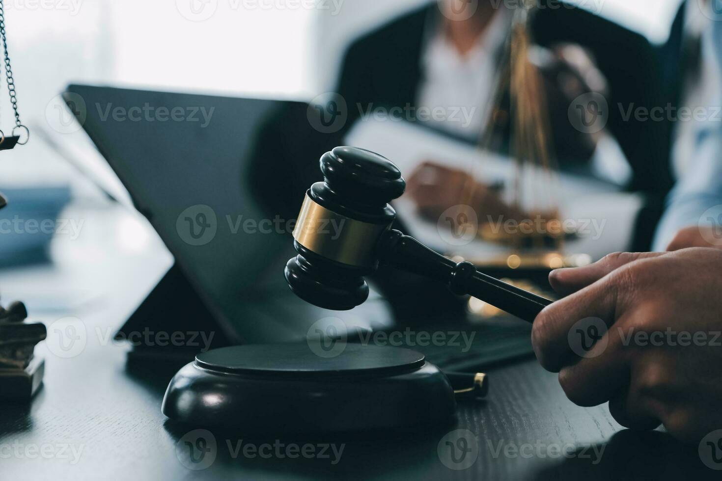 Business and lawyers discussing contract papers with brass scale on desk in office. Law, legal services, advice, justice and law concept picture with film grain effect photo