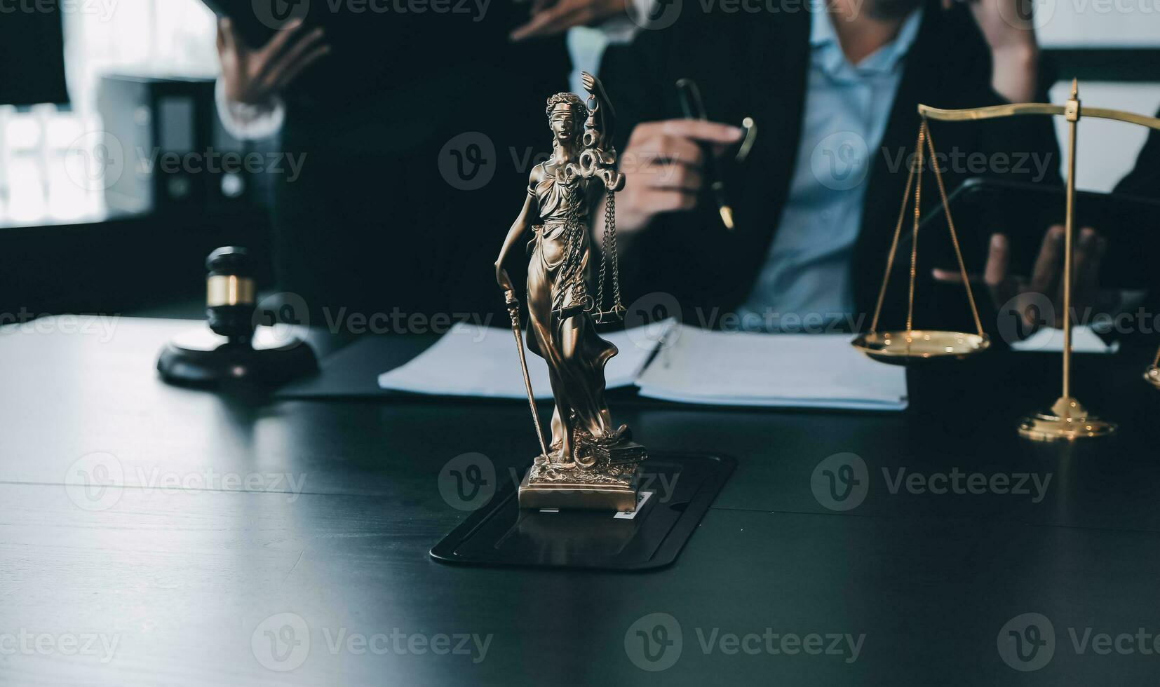Business and lawyers discussing contract papers with brass scale on desk in office. Law, legal services, advice, justice and law concept picture with film grain effect photo