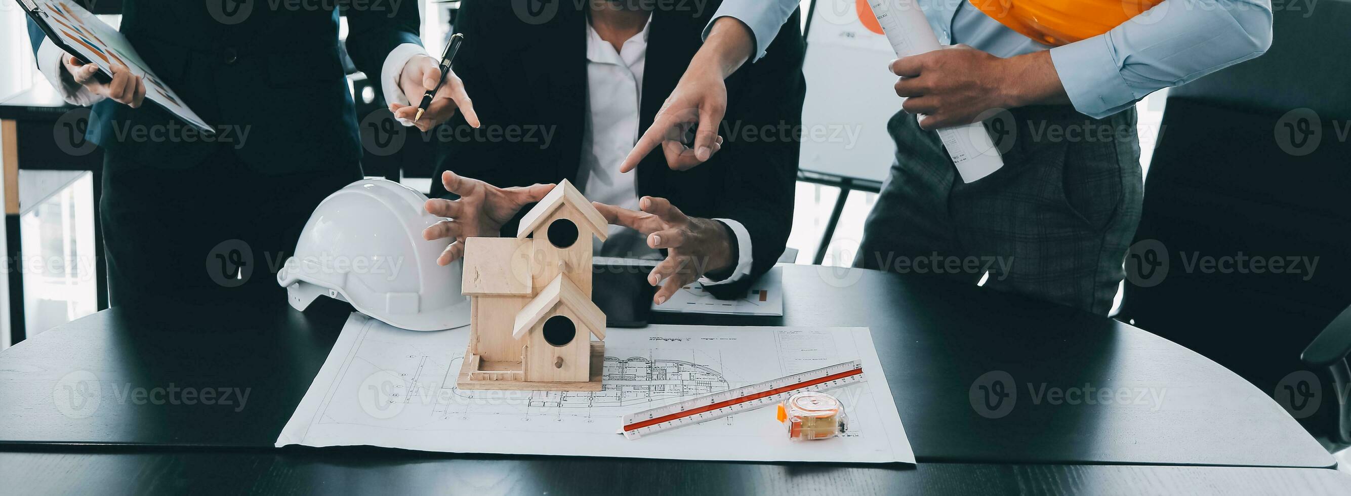 Construction and structure concept of Engineer or architect meeting for project working with partner and engineering tools on model building and blueprint in working site, contract for both companies. photo