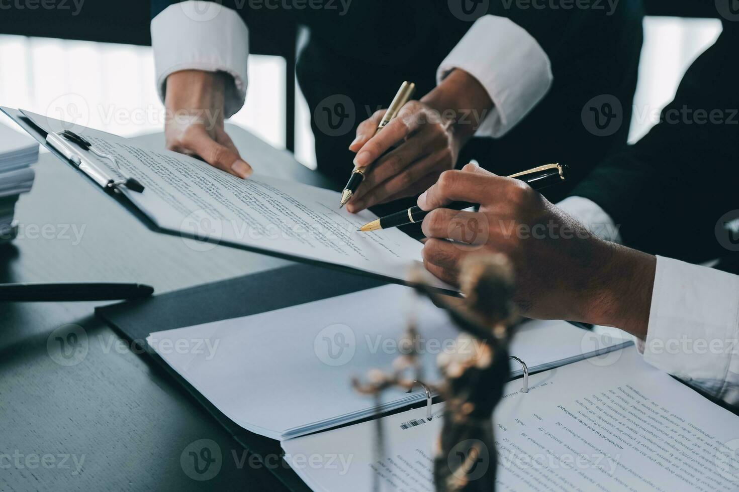 Business and lawyers discussing contract papers with brass scale on desk in office. Law, legal services, advice, justice and law concept picture with film grain effect photo