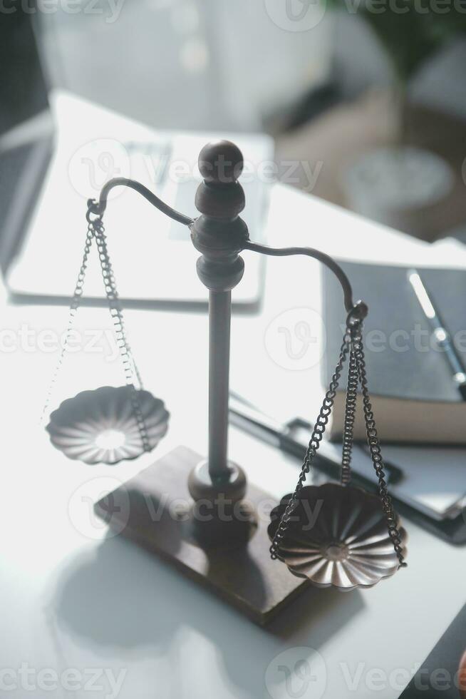 Business and lawyers discussing contract papers with brass scale on desk in office. Law, legal services, advice, justice and law concept picture with film grain effect photo