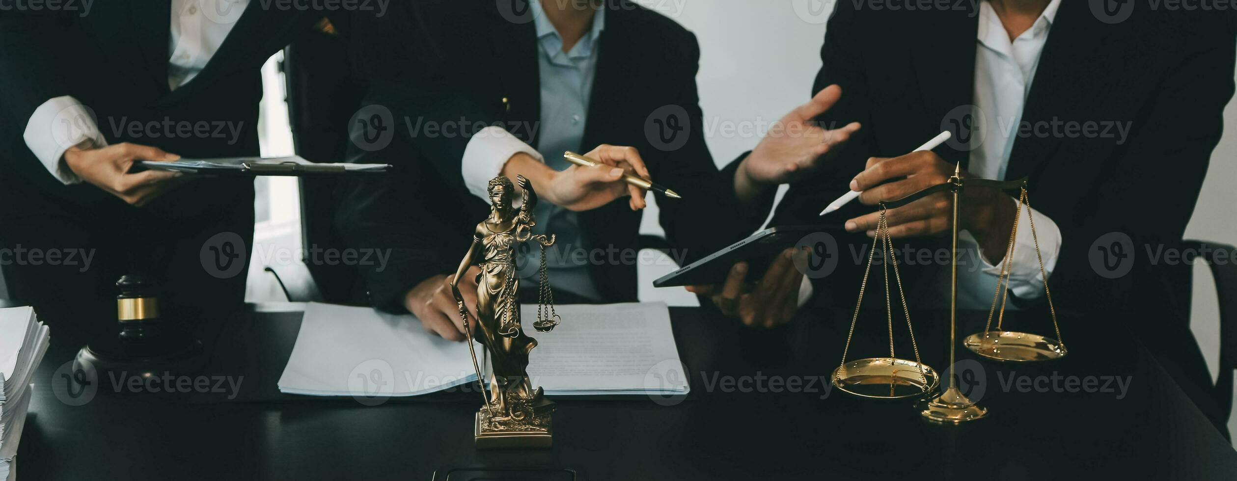 Business and lawyers discussing contract papers with brass scale on desk in office. Law, legal services, advice, justice and law concept picture with film grain effect photo