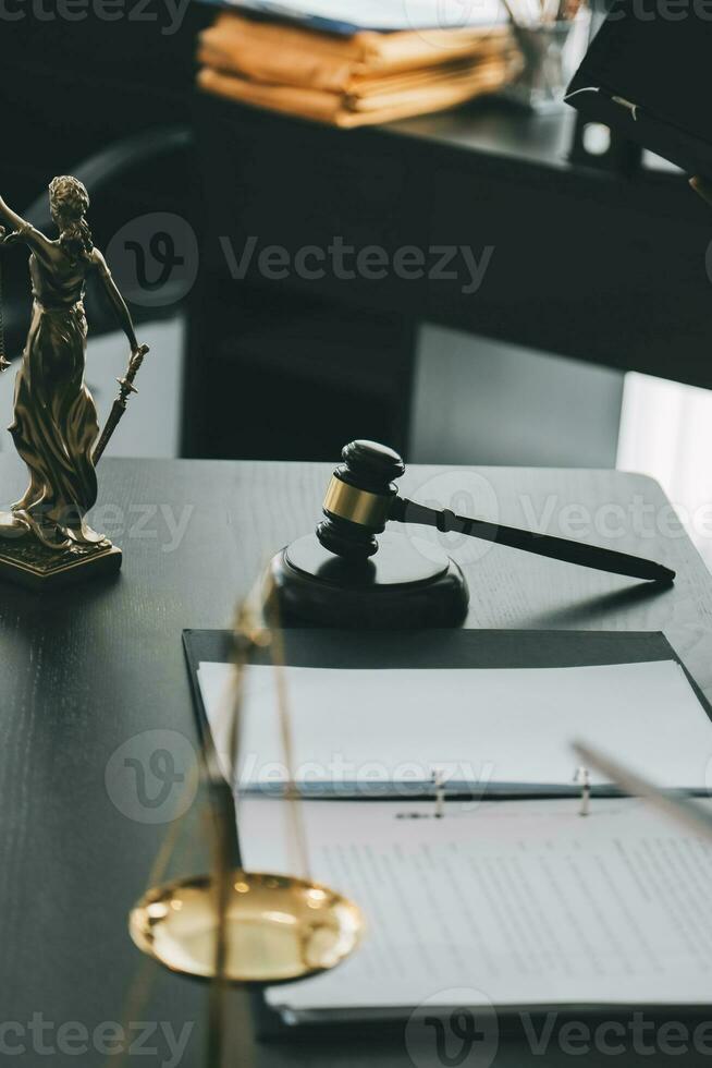 Business and lawyers discussing contract papers with brass scale on desk in office. Law, legal services, advice, justice and law concept picture with film grain effect photo