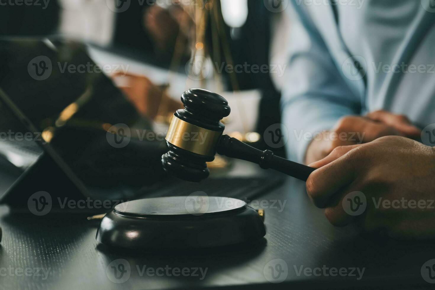 Business and lawyers discussing contract papers with brass scale on desk in office. Law, legal services, advice, justice and law concept picture with film grain effect photo