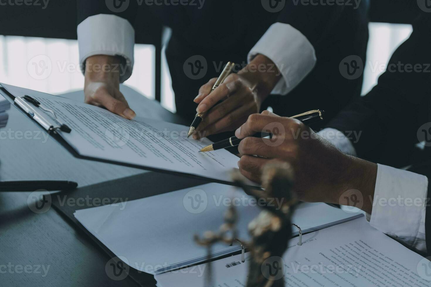 Business and lawyers discussing contract papers with brass scale on desk in office. Law, legal services, advice, justice and law concept picture with film grain effect photo