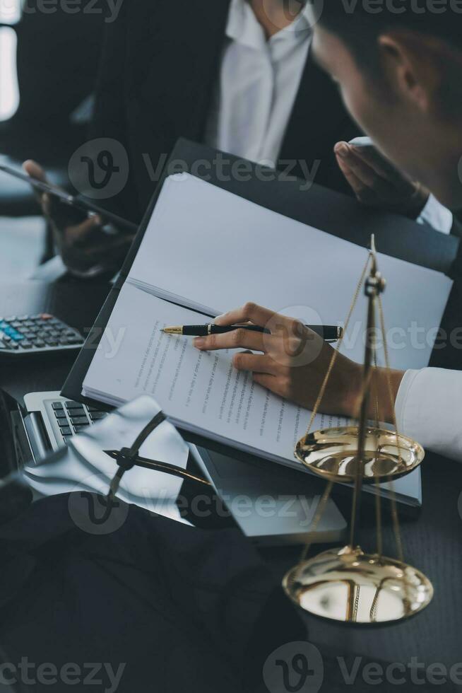 Business and lawyers discussing contract papers with brass scale on desk in office. Law, legal services, advice, justice and law concept picture with film grain effect photo