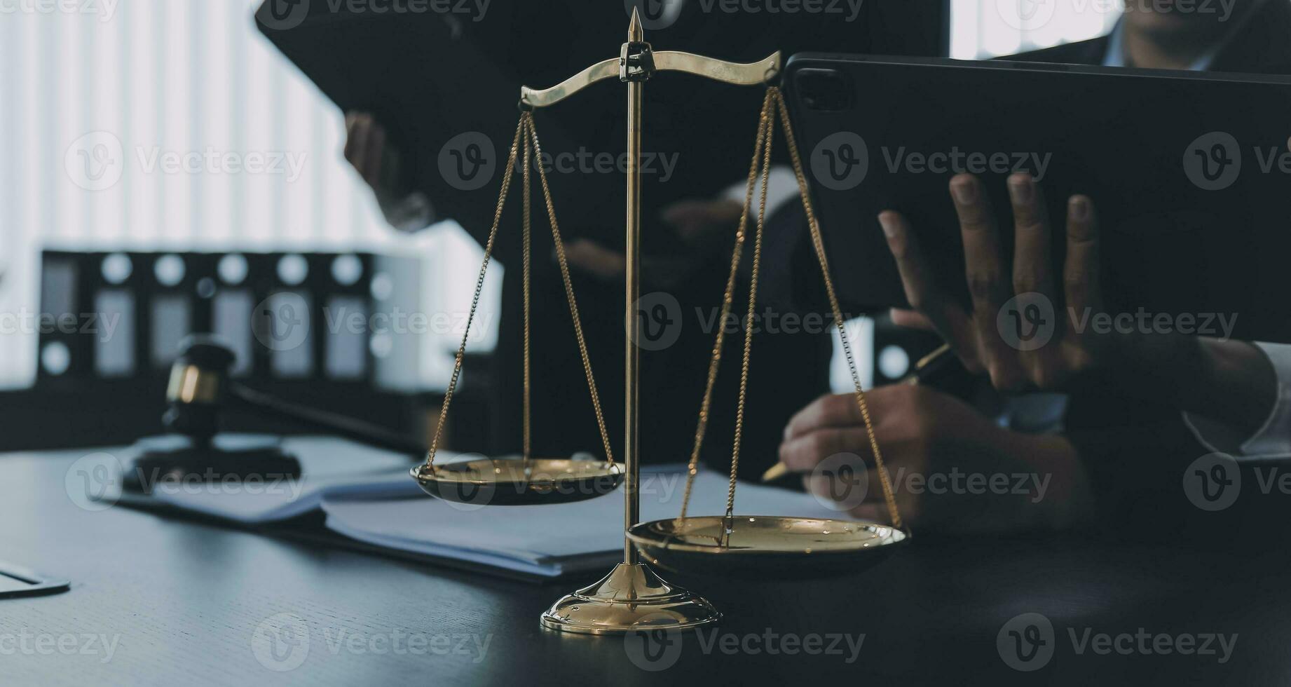 Business and lawyers discussing contract papers with brass scale on desk in office. Law, legal services, advice, justice and law concept picture with film grain effect photo