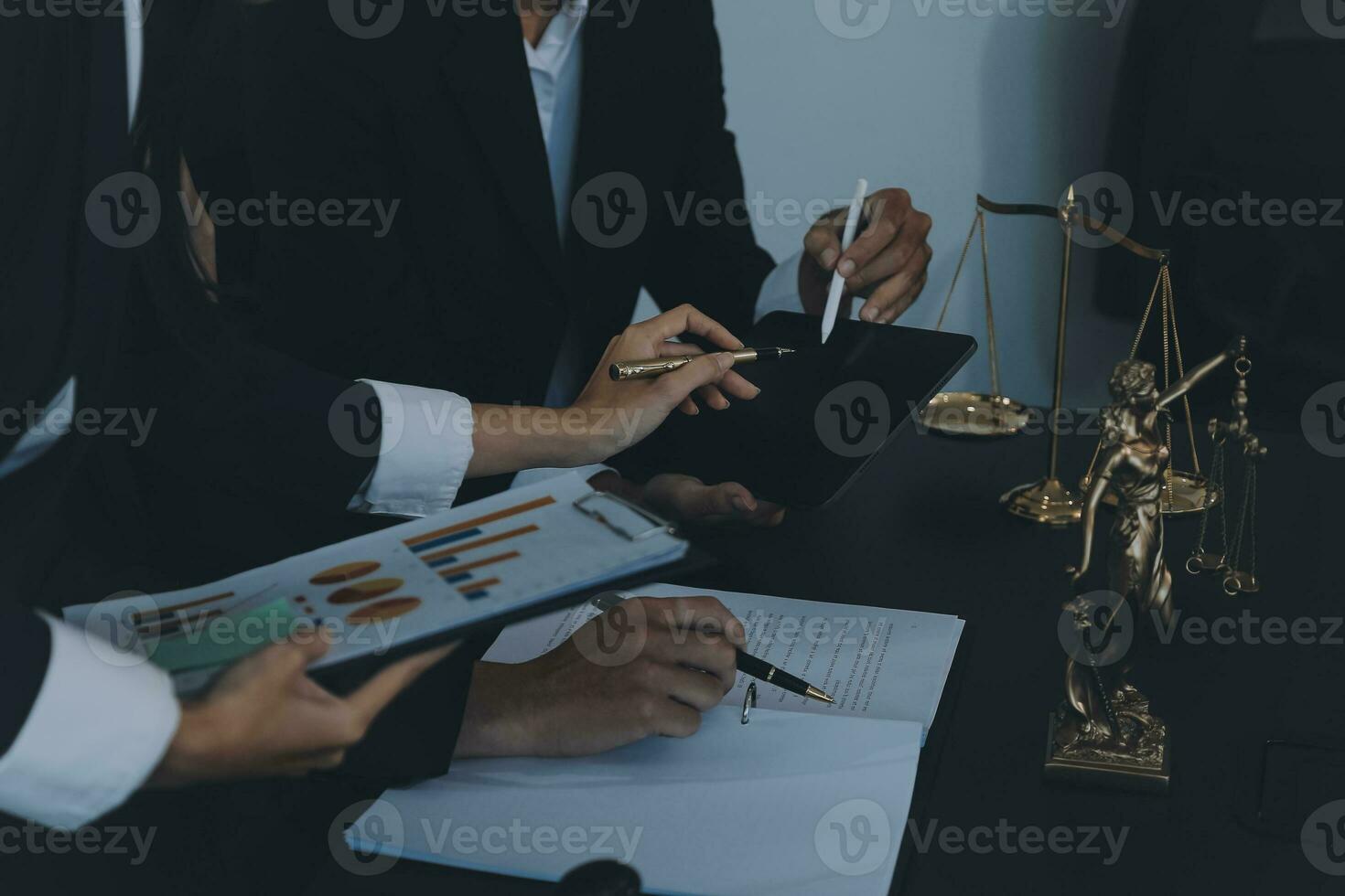 Business and lawyers discussing contract papers with brass scale on desk in office. Law, legal services, advice, justice and law concept picture with film grain effect photo