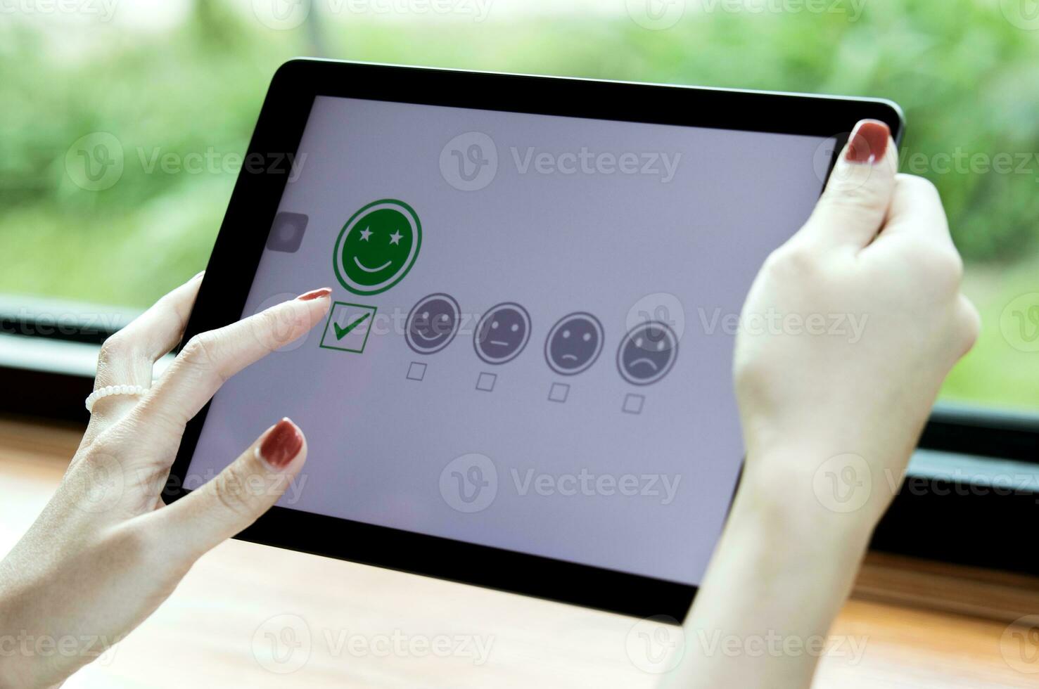 Customers choose emoticons rating to service on online application. concept of customer satisfaction surveys, reviews of store products to evaluate the quality leading to business reputation ranking. photo