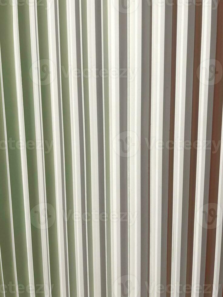 Decorative construction of white plastic planks. Vertical white stripes. Abstract background. Geometric grid. Vertical composition. Mesh geometric. Grille panel pattern perspective view. photo