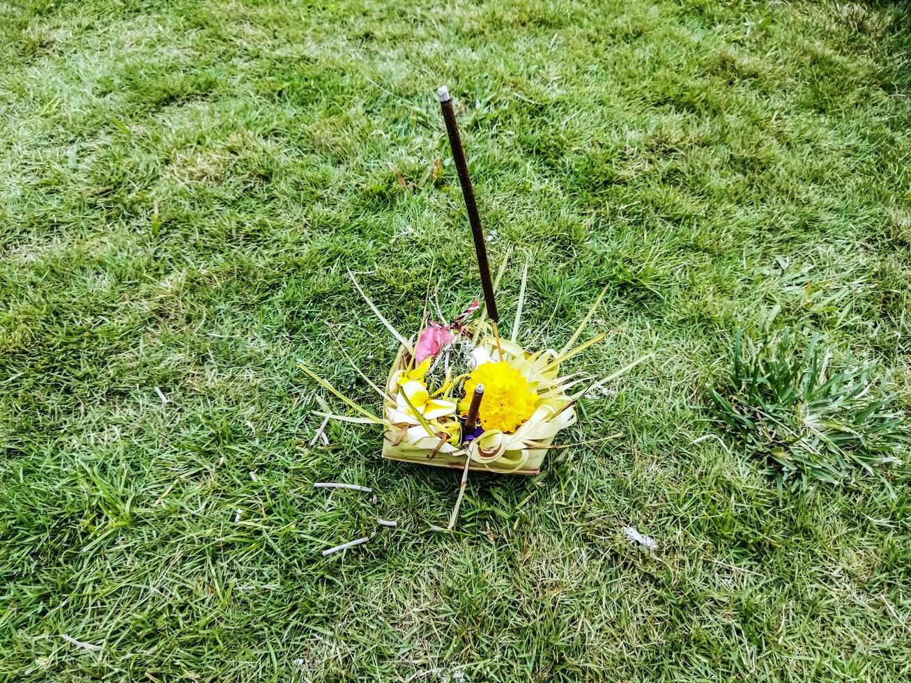 Defocus Food and flowers offerings of Balinese Traditional Culture and Ceremony Hindu Bali called Sesajen with incense burning. Copy space. photo