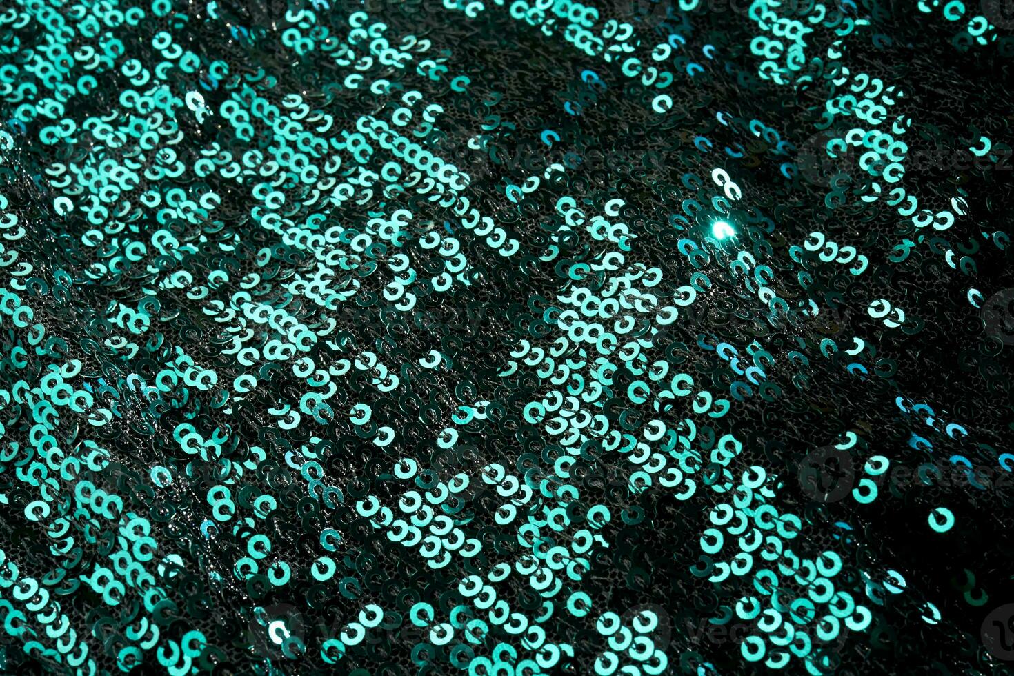 Christmas abstract background made of emerald green sequins. photo