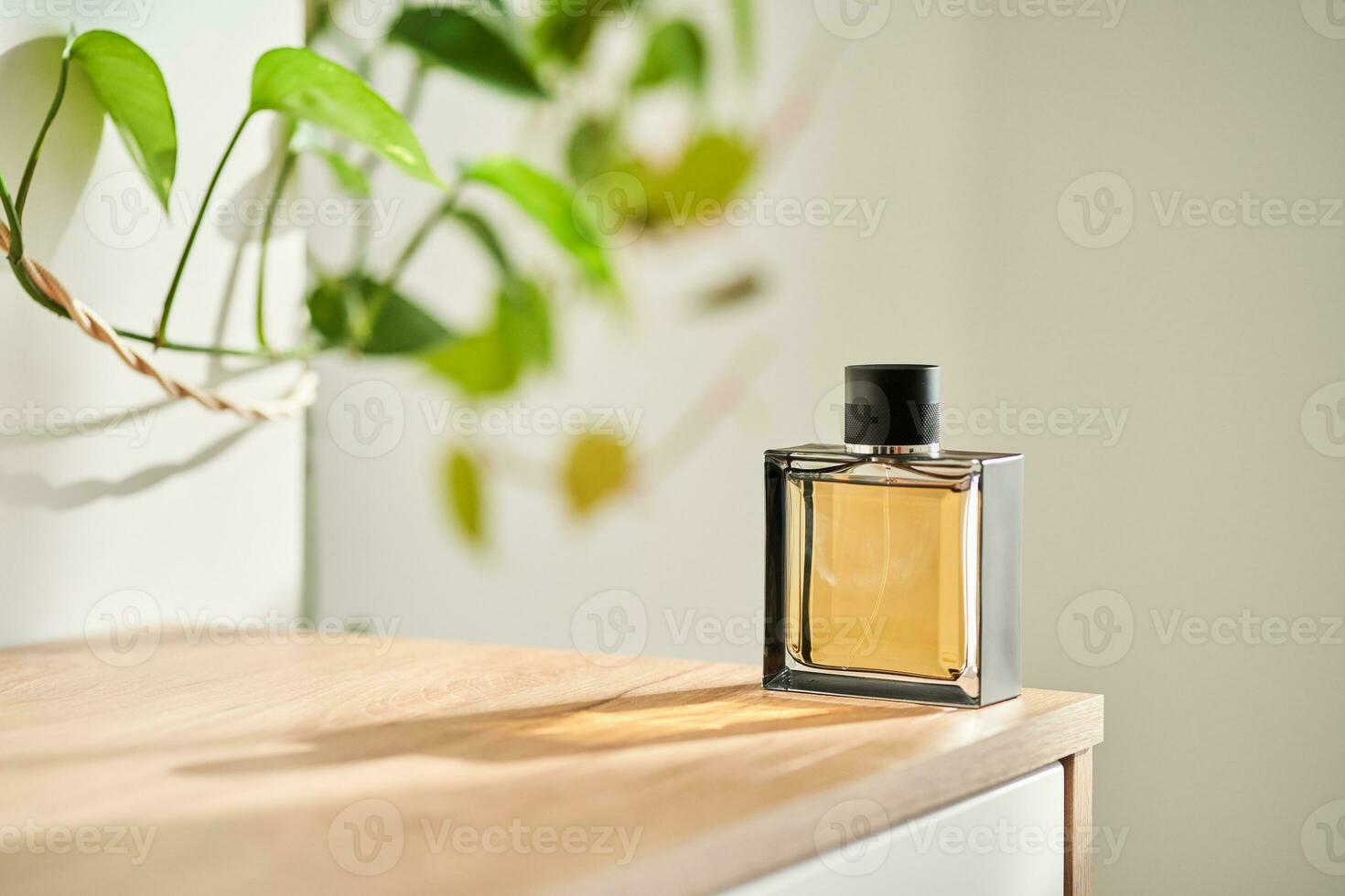 A bottle of perfume in the rays of the sun. photo