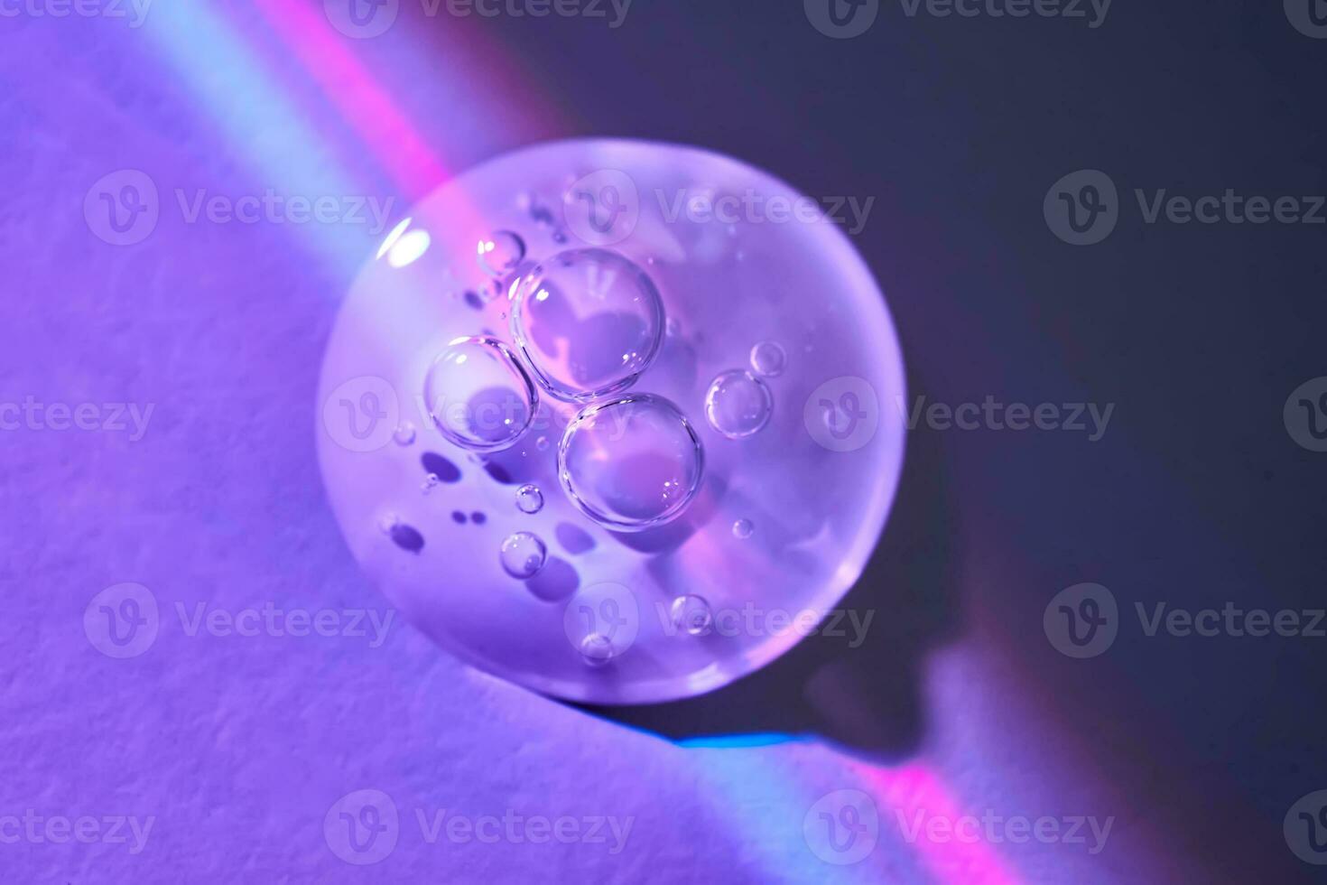 A drop of serum under ultraviolet light. photo