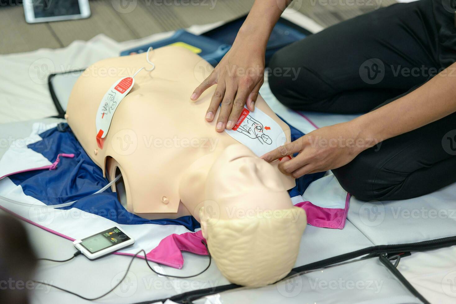 First aid cardiopulmonary resuscitation course using AED training. selective focus placing electrode photo