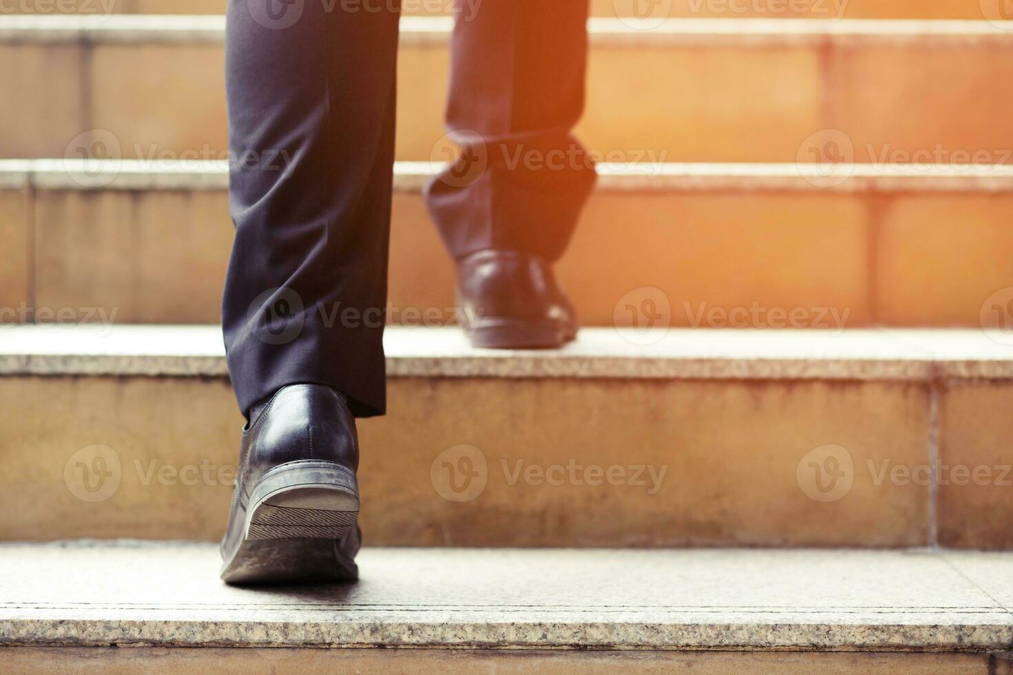 modern businessman working  close-up legs walking up the stairs in modern city. in rush hour to work in office a hurry. During the first morning of work. stairway. soft focus. photo