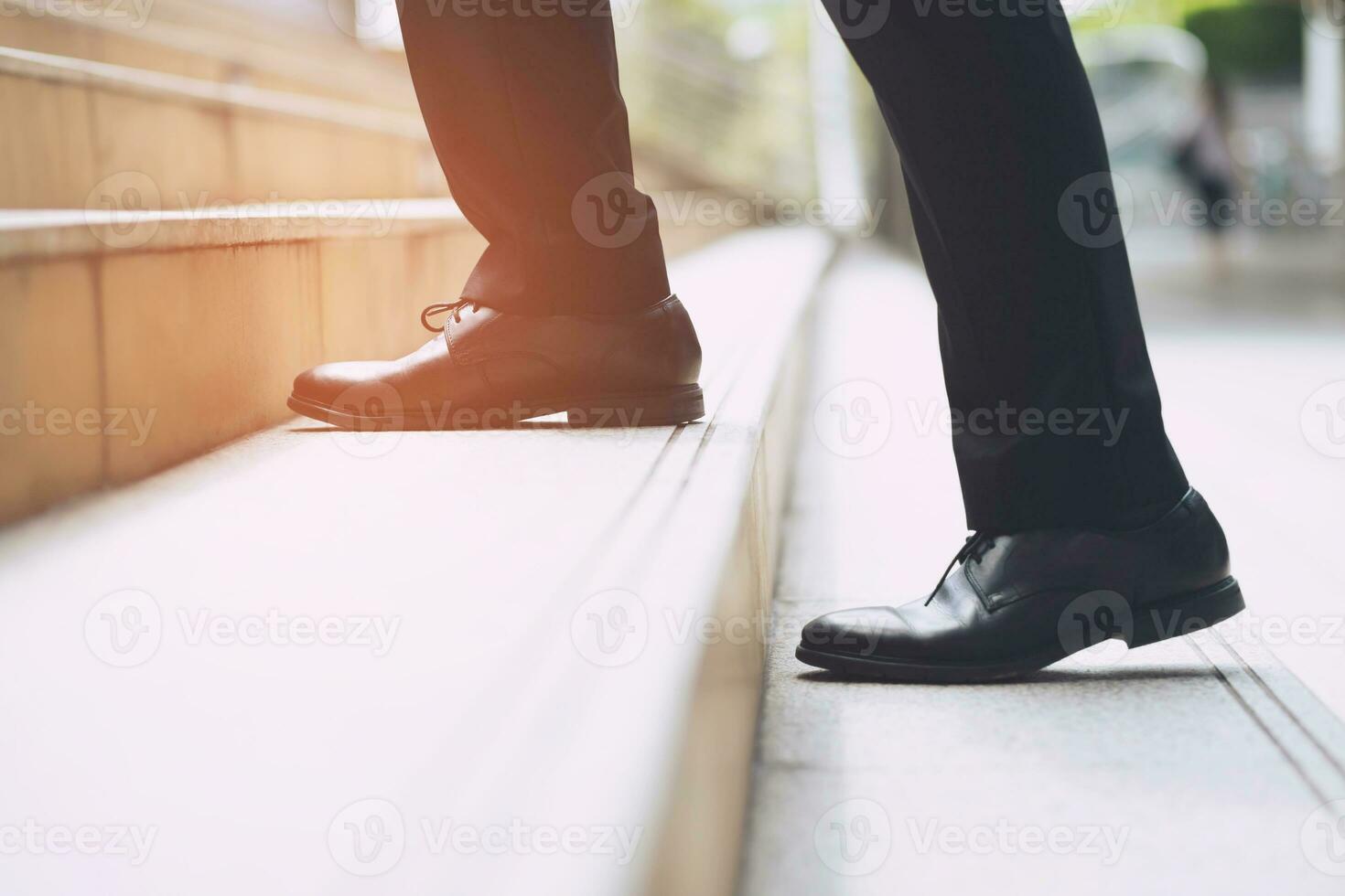 modern businessman working  close-up legs walking up the stairs in modern city. in rush hour to work in office a hurry. During the first morning of work. stairway. soft focus. photo