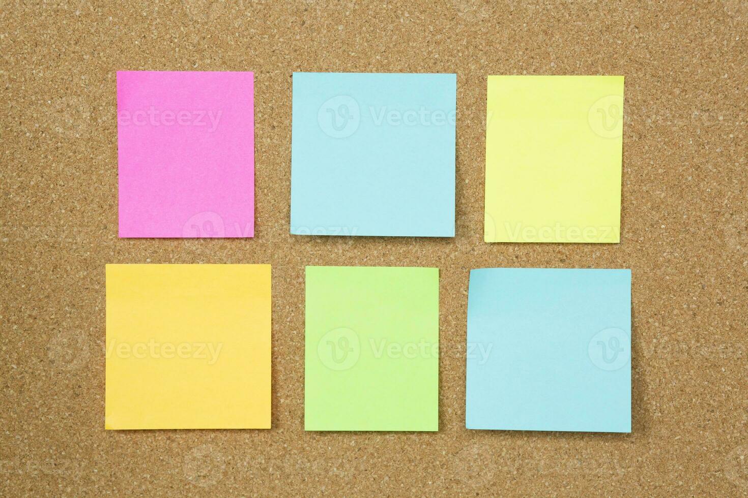 collection of colorful variety post it. paper note reminder sticky notes pin paper blue  on cork bulletin board. empty space for text photo