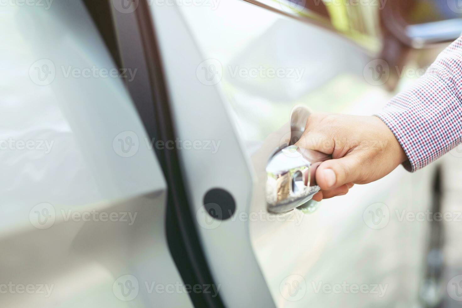 Close up image of a businessman hand on handle opening a car door. Pull the door to you. photo