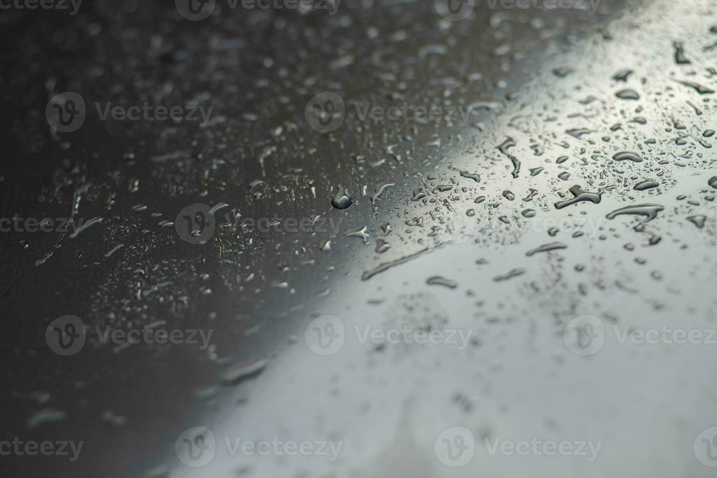 Drops Of Rain Drizzle on the glass windshield in the evening. street in the heavy rain. Bokeh Tail light. soft Focus. Please drive carefully, slippery road. soft focus. photo