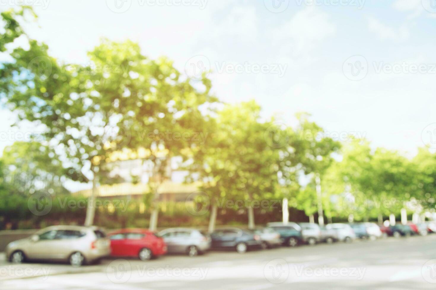 photo blurred aerial car parking lot outdoors Square, cars in row Parking on the side of the road and evening sun. Leave space empty for text.