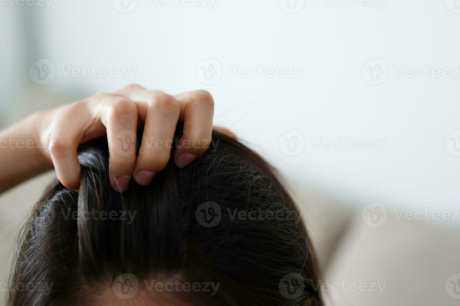 A woman has problems with hair and scalp,she has dandruff from allergic reactions to shampoos. and hair conditioner photo