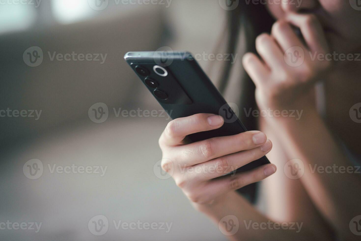 sad people casual wear sitting on sofa using call talking  mobile phone during Symptoms  unhappy female holding his forehead while having headache receive a bad news message. photo