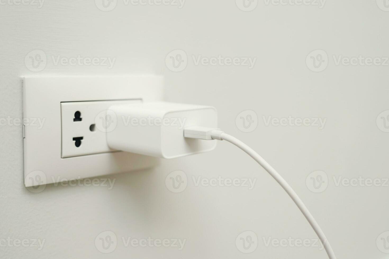 Close Up the electrical power socket and plug socket on wall. photo