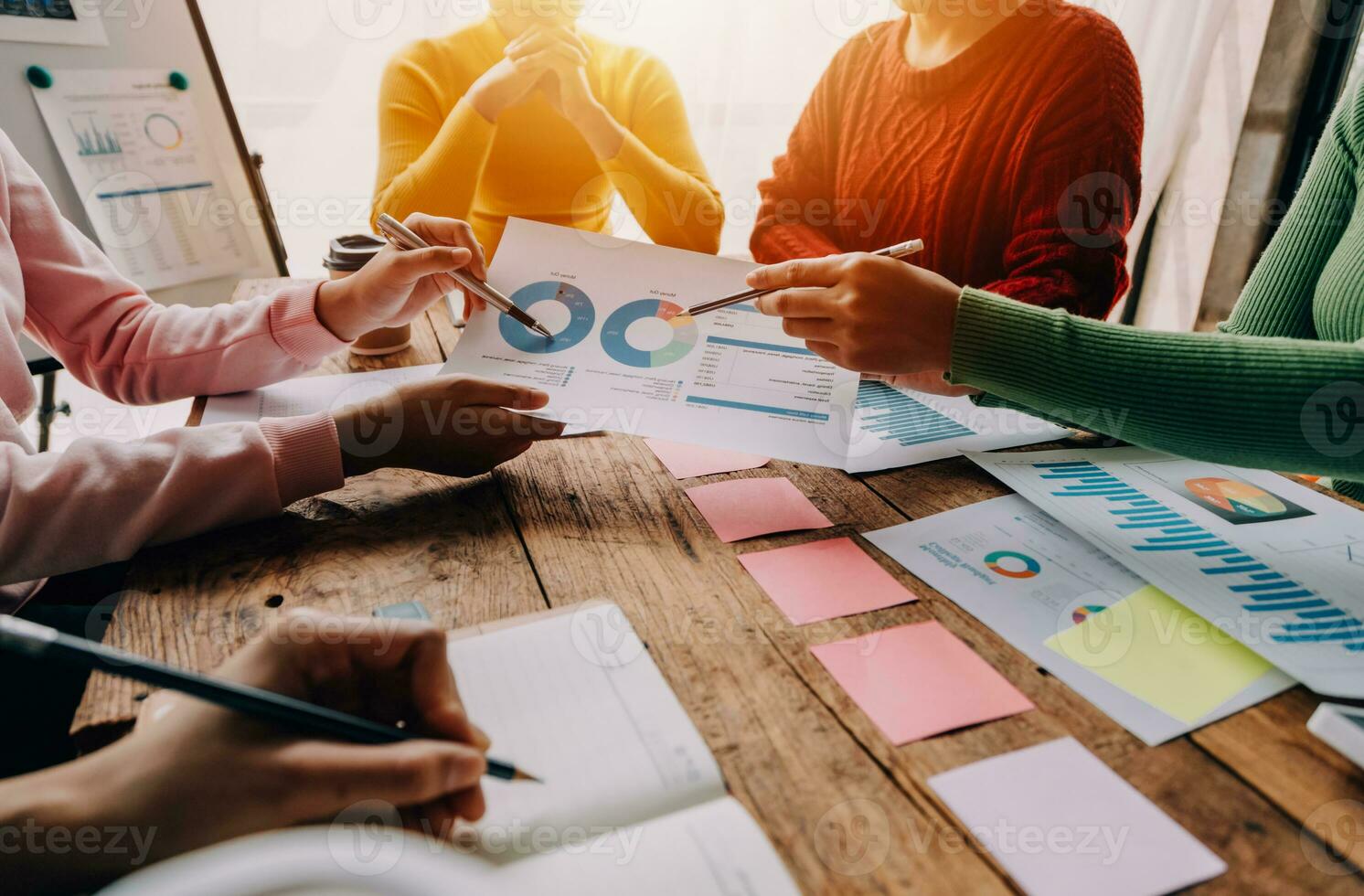 Financial analysts analyze business financial reports on a digital tablet planning investment project during a discussion at a meeting of corporate showing the results of their successful teamwork. photo