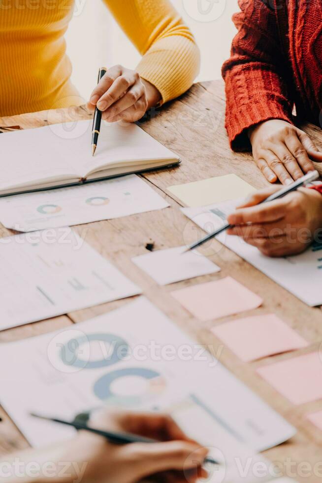 Financial analysts analyze business financial reports on a digital tablet planning investment project during a discussion at a meeting of corporate showing the results of their successful teamwork. photo