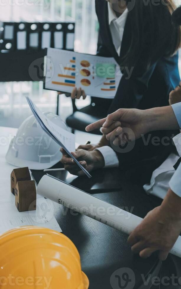 Construction and structure concept of Engineer or architect meeting for project working with partner and engineering tools on model building and blueprint in working site, contract for both companies. photo