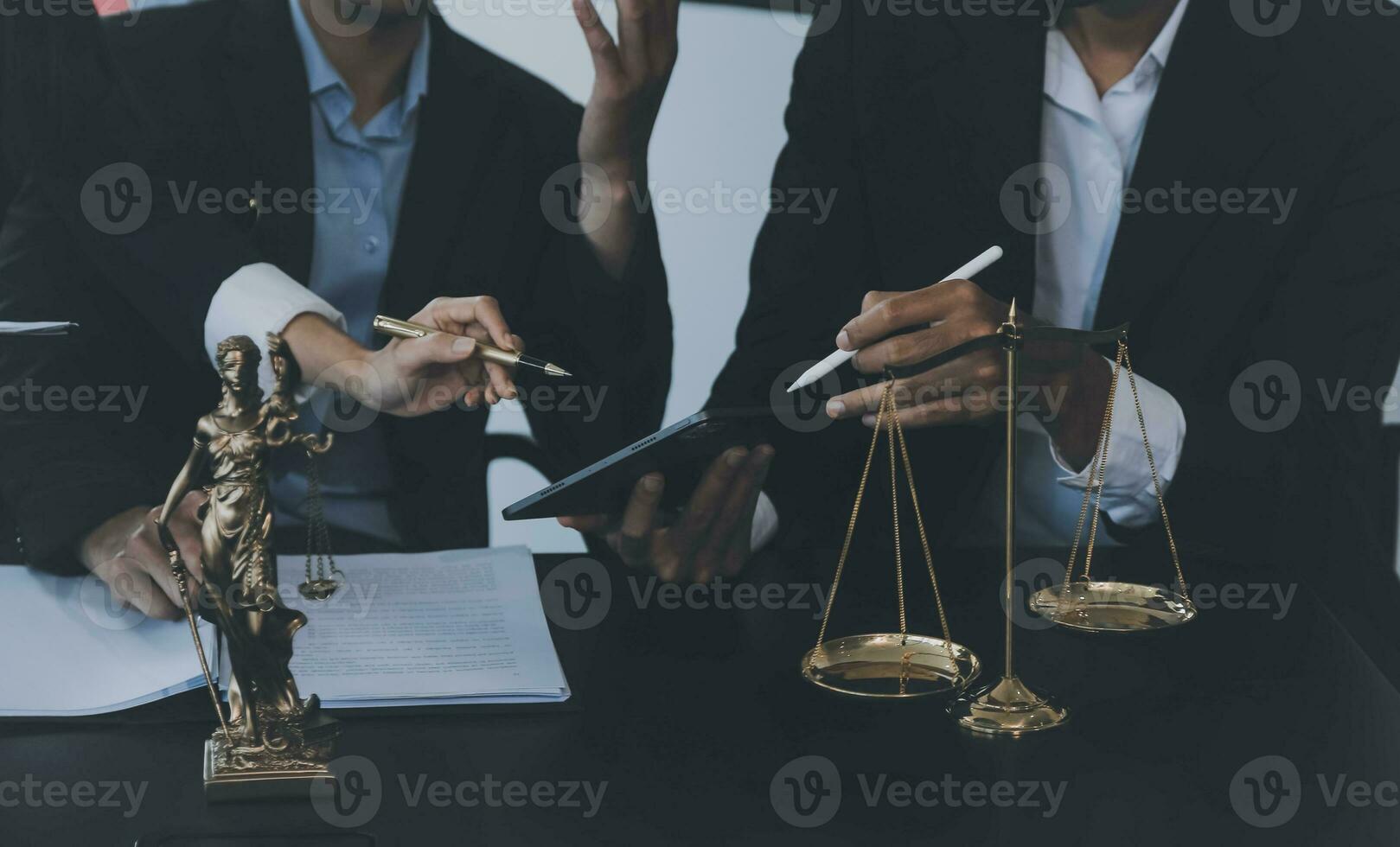 Business and lawyers discussing contract papers with brass scale on desk in office. Law, legal services, advice, justice and law concept picture with film grain effect photo