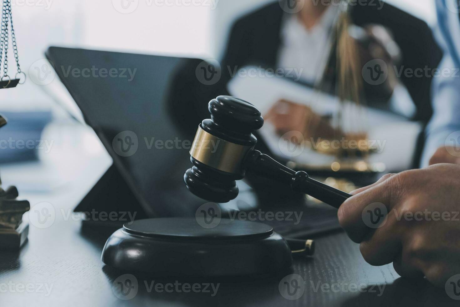 Business and lawyers discussing contract papers with brass scale on desk in office. Law, legal services, advice, justice and law concept picture with film grain effect photo