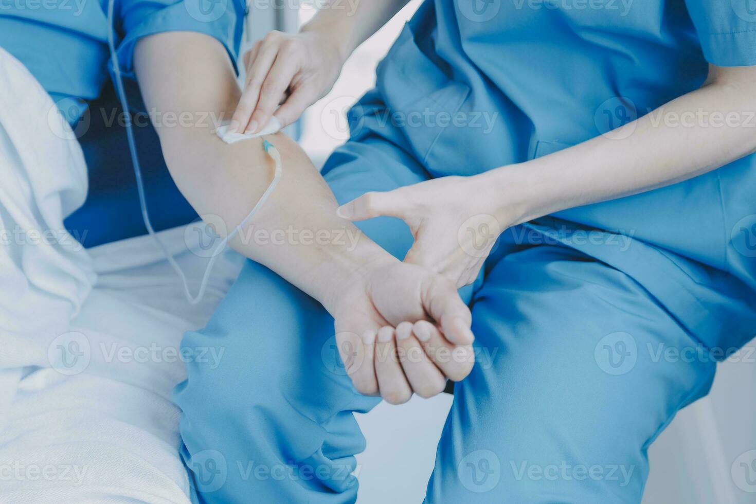 Injured patient showing doctor broken wrist and arm with bandage in hospital office or emergency room. Sprain, stress fracture or repetitive strain injury in hand. Nurse helping customer. First aid. photo