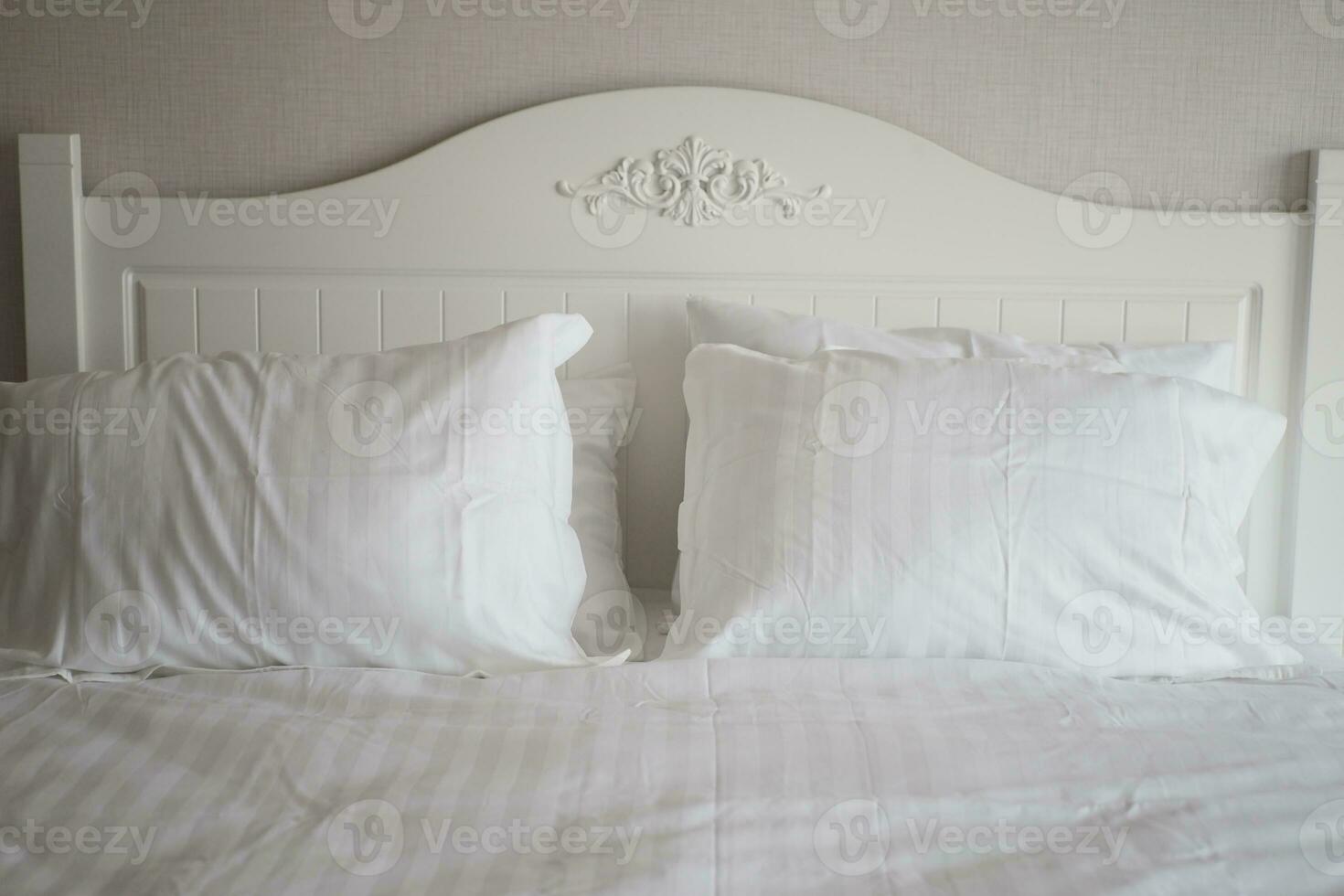 white pillow lined up on bed photo