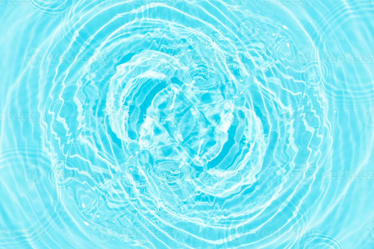 Defocus blurred transparent blue colored clear calm water surface texture with splashes reflection. Trendy abstract nature background. Water waves in sunlight with copy space. Blue watercolor shine. photo