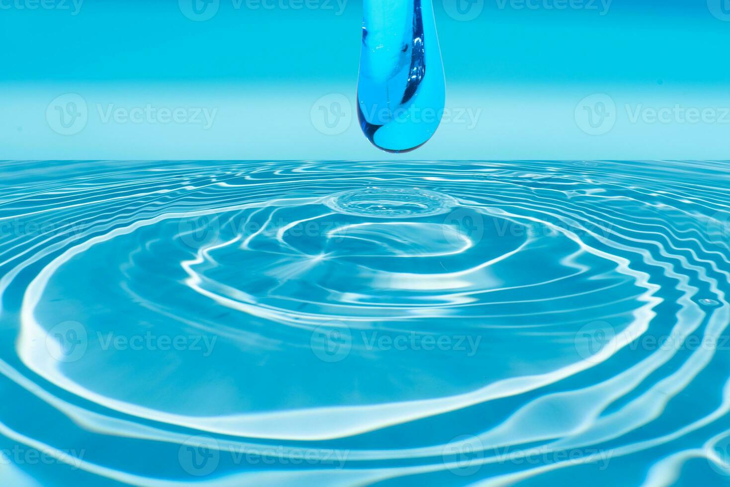 Defocus blurred transparent blue colored clear calm water surface texture with splashes reflection. Trendy abstract nature background. Water waves in sunlight with copy space. Blue watercolor shine. photo