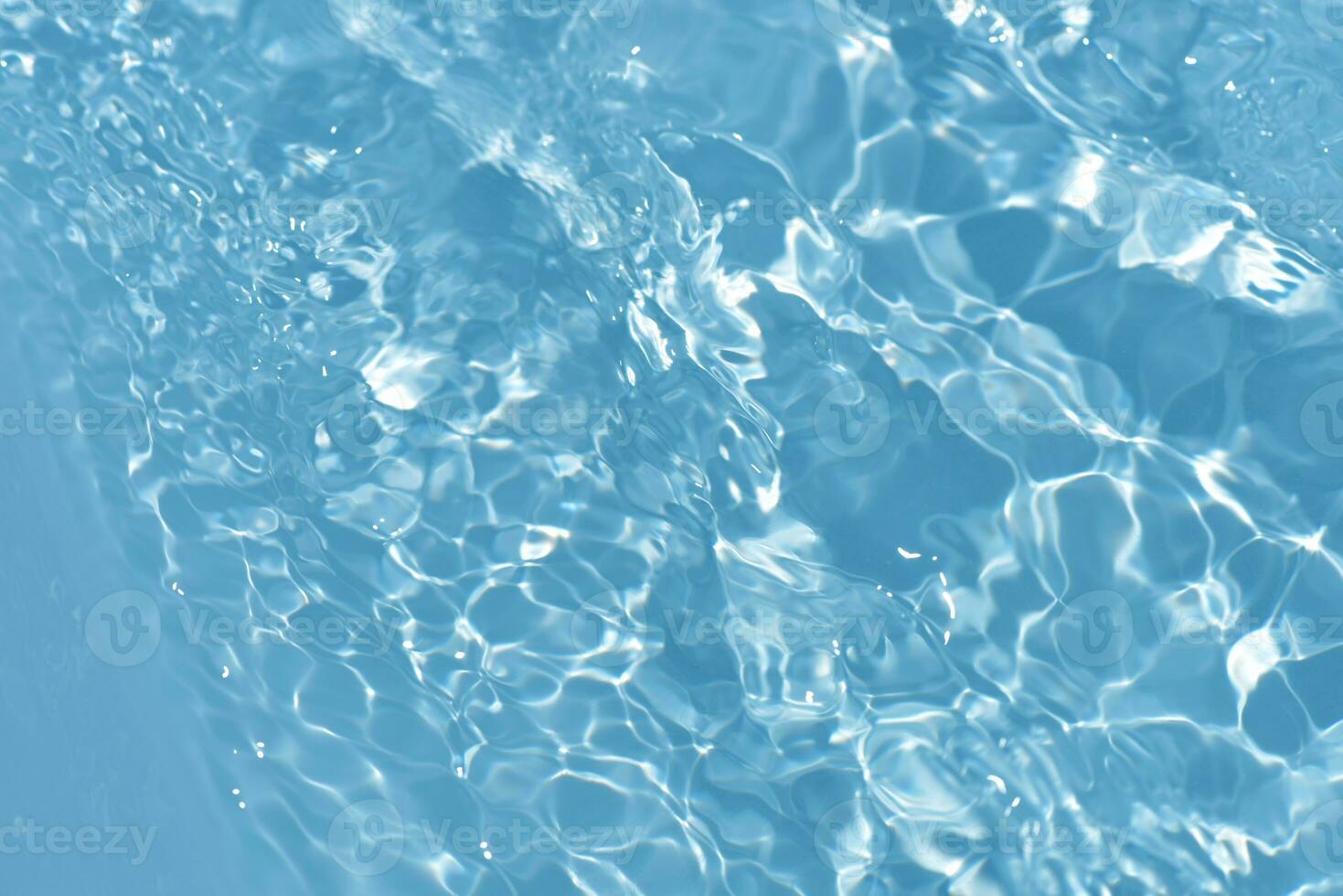 Defocus blurred transparent blue colored clear calm water surface texture with splashes reflection. Trendy abstract nature background. Water waves in sunlight with copy space. Blue watercolor shine. photo