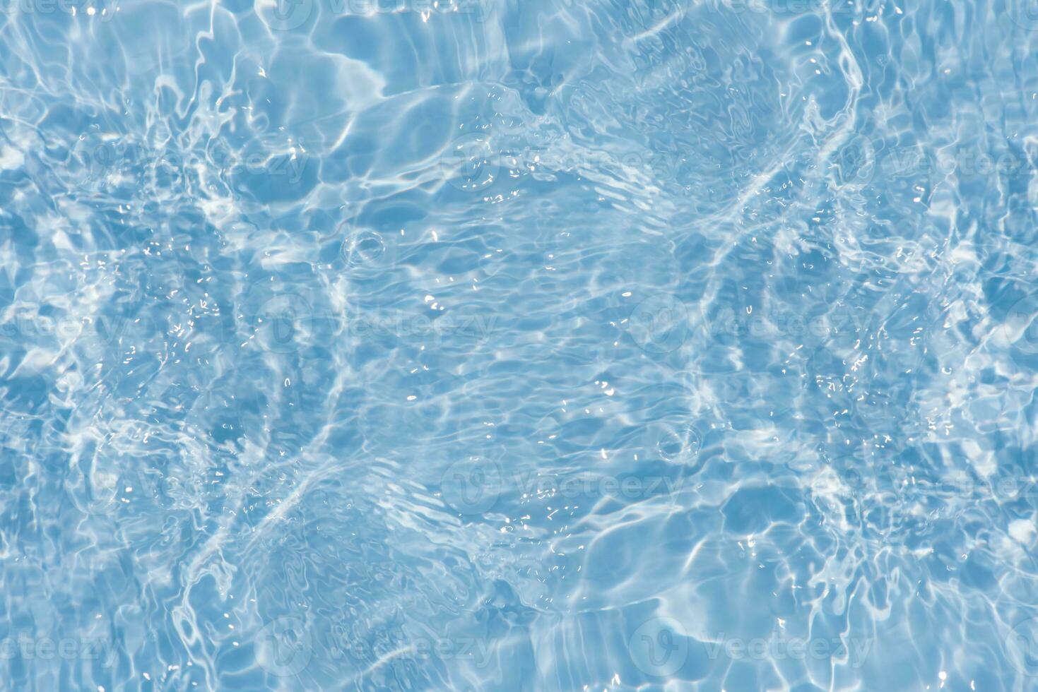 Defocus blurred transparent blue colored clear calm water surface texture with splashes reflection. Trendy abstract nature background. Water waves in sunlight with copy space. Blue watercolor shine. photo
