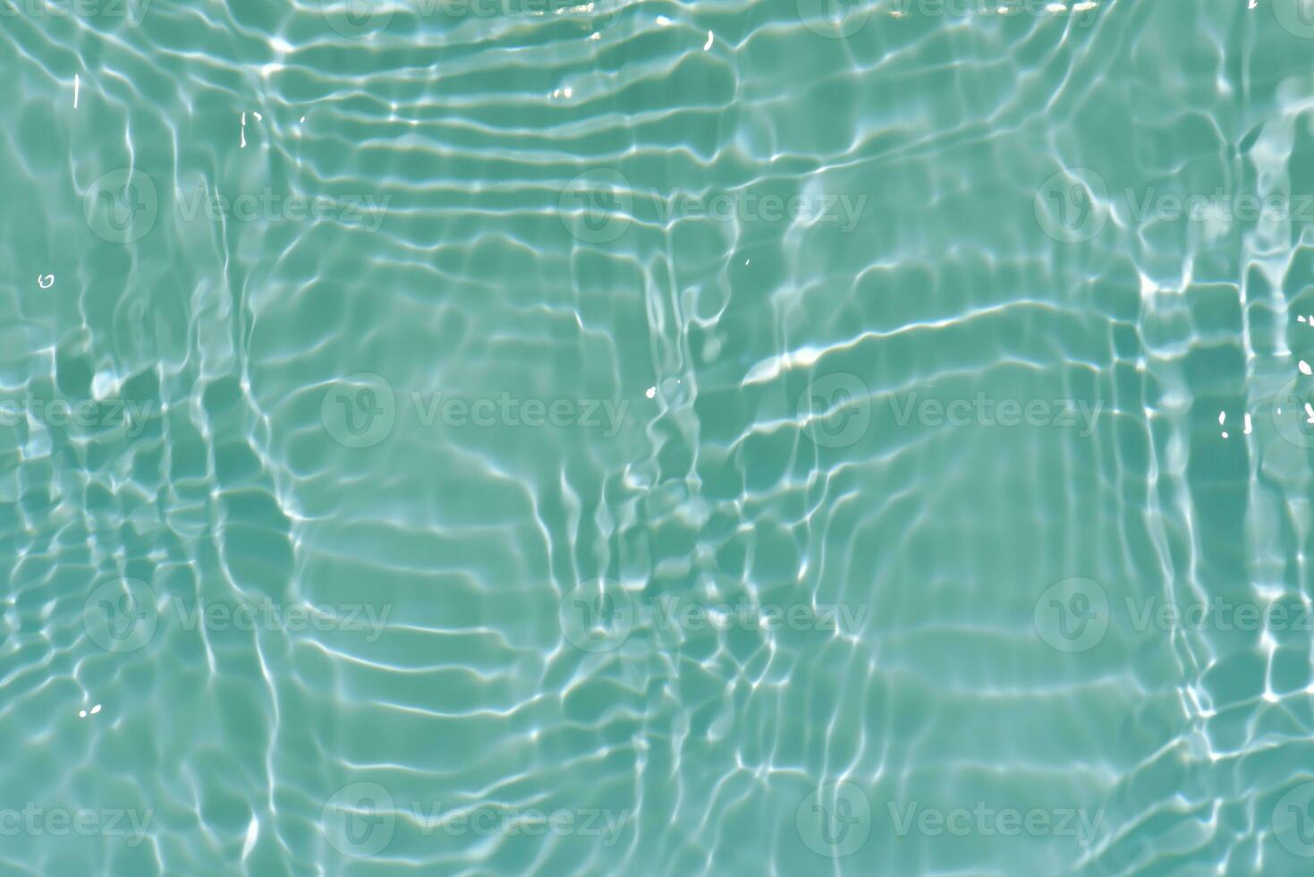 Defocus blurred transparent blue colored clear calm water surface texture with splashes reflection. Trendy abstract nature background. Water waves in sunlight with copy space. Blue watercolor shine. photo