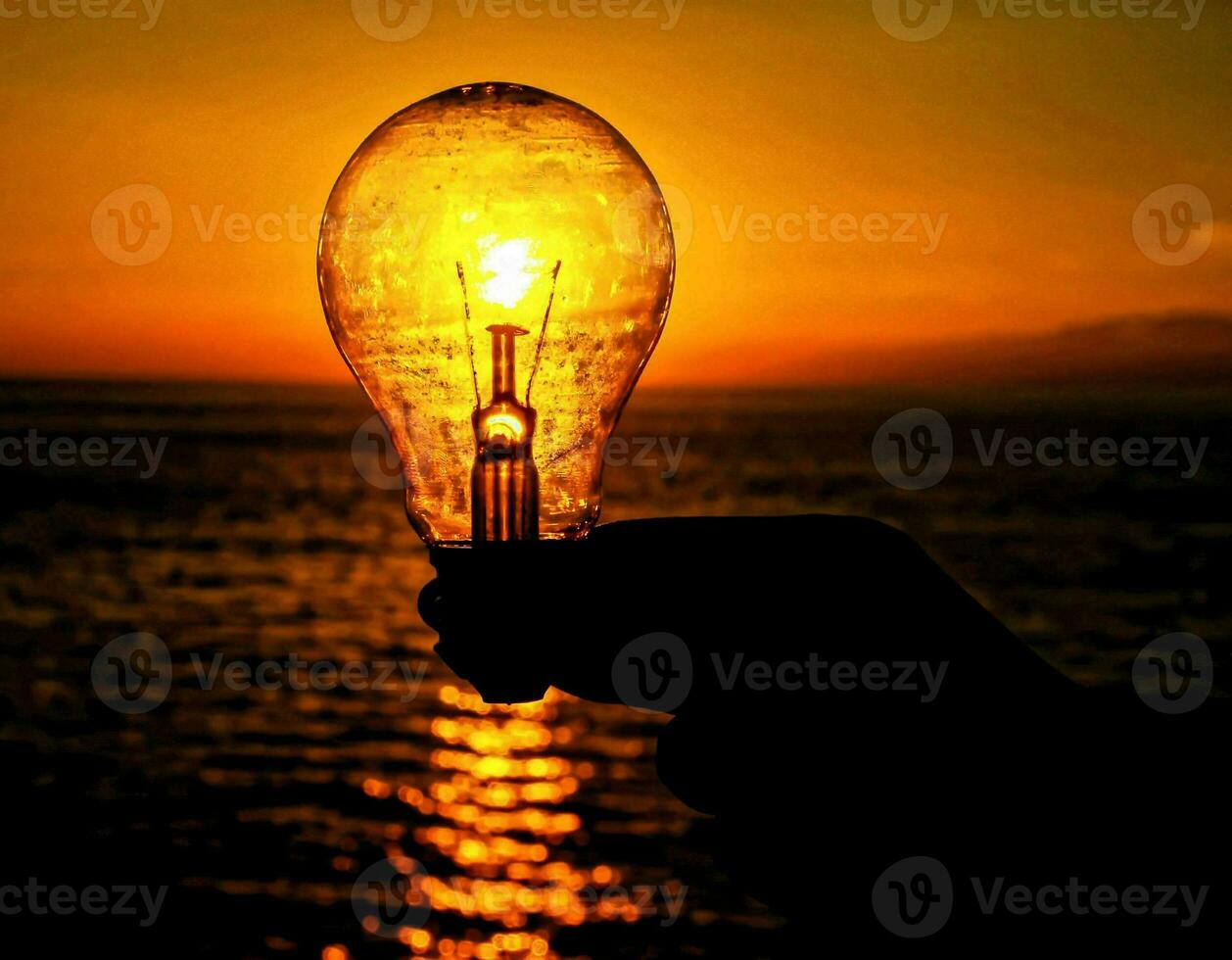 Light bulb and sunset photo
