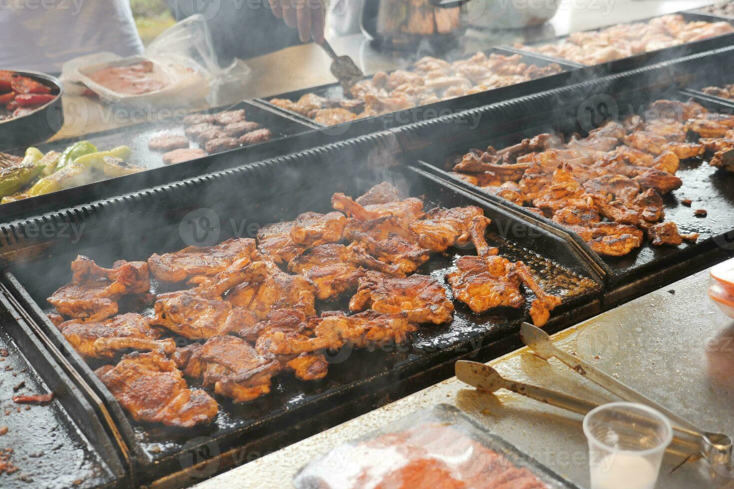 Beef and chicken steaks on the grill with flames. photo