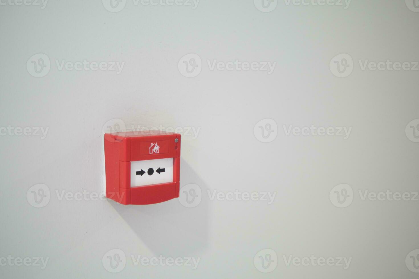 Red fire alarm button on wall , photo