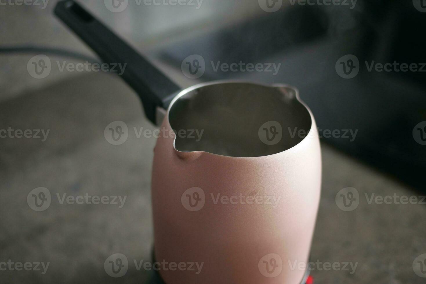 hot water in a jar on table photo