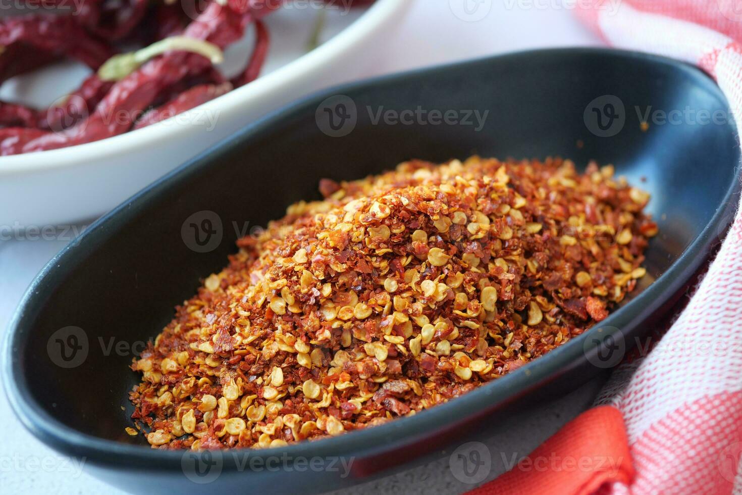 chili flakes in a bowl on table photo